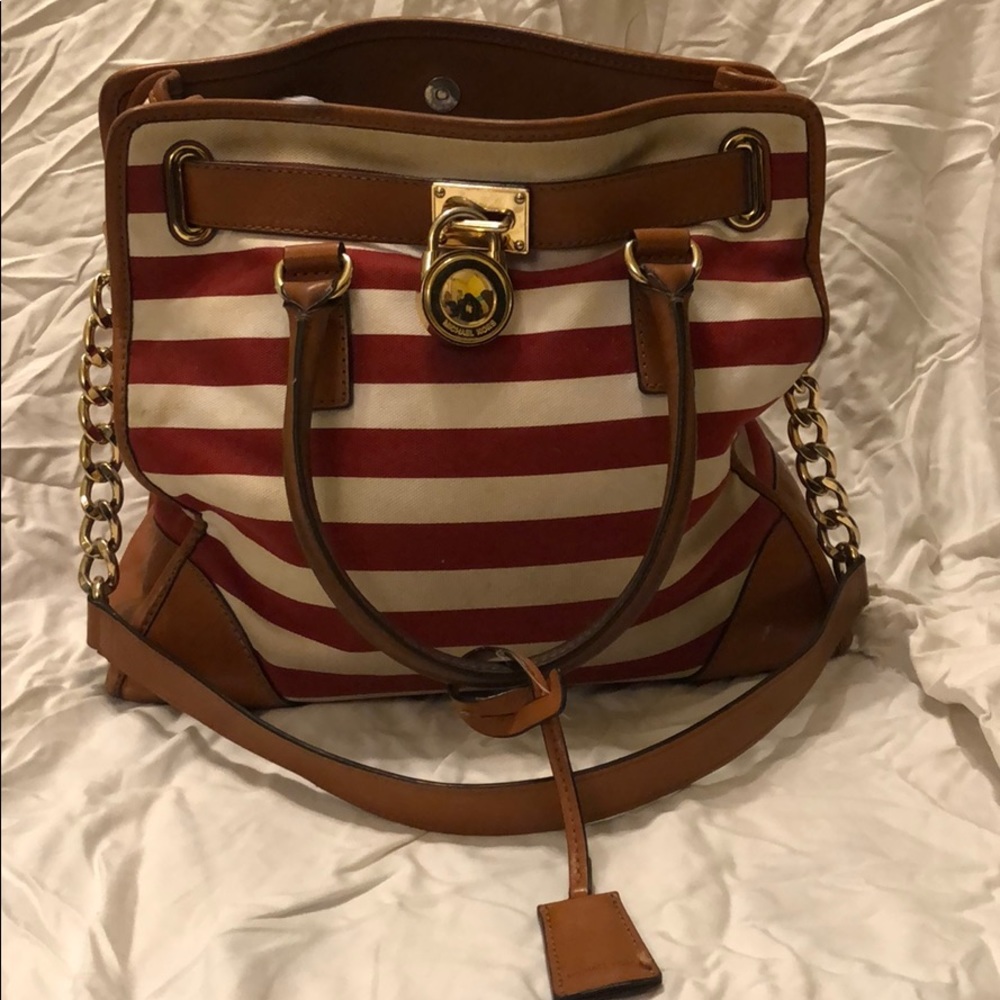 A striped Miicheal Khors purse